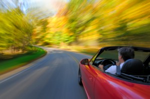 man driving fast in car